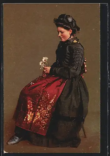 AK Brigels, Frau in Tracht mit Gänseblumen