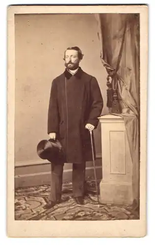 Fotografie W. Rupp, Prag, Portrait Herr Scholling im Anzug mit Zylinder und Flanierstock