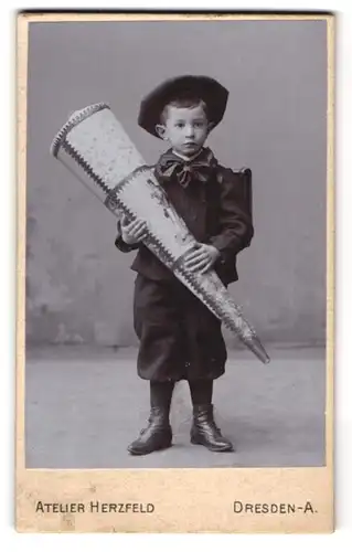 Fotografie Atelier Herzfeld, Dresden, niedlicher Knabe zum ersten Schultag mit grosser Zuckertüte und Schulranzen