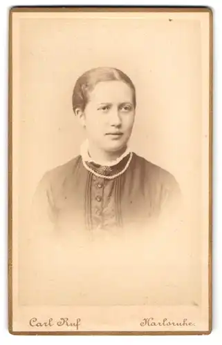 Fotografie Carl Ruf, Karlsruhe, Amalienstr. 26, Gutaussehende junge Frau mit Perlenkette und skeptischen Blick
