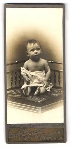 Fotografie Emil Clausen, Kobenhavn, Frederiksberggade 34, Niedliches Baby im weissen Kleid schaut erstaunt zur Seite