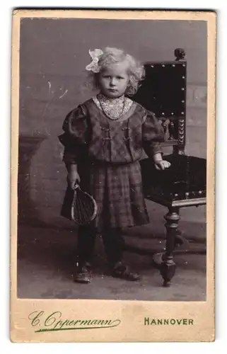 Fotografie Carl Oppermann, Hannover, Engelbostelerdamm 4, Niedliches kleines Mädchen im dunklen Kleid mit Schleife