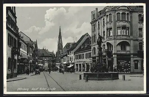 AK Offenburg, Strasse mit Geschäften, Kirche und Brunnen