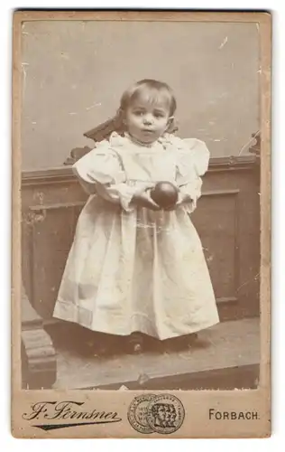 Fotografie F. Fernsner, Forbach, Nationalstrasse, Kleines Mädchen in weissem Kleid mit einem Ball