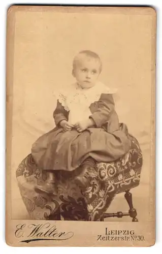 Fotografie E. Walter, Leipzig, Zeitzerstr. 30, Kleines Mädchen im Kleid mit Zierkragen, mit melancholischem Blick