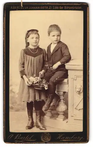 Fotografie A. Bartel, Hamburg, Johannisstr. 21, Bruder und Schwester in Sonntagsgarderobe mit einem Korb voll Blumen