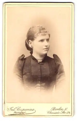 Fotografie Jul. Casparius, Berlin N., Chaussée-Str. 34, Mädchen im Kleid mit betonten Schultern, mit drei-reihiger Kette