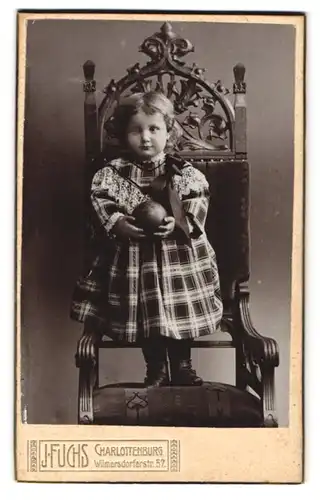 Fotografie J. Fuchs, Charlottenburg, Wilmersdorferstr. 57, Kleines Mädchen im karierten Kleid mit einem Ball in der Hand
