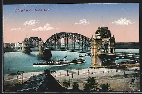 AK Düsseldorf, Rheinbrücke mit einem Raddampfer, den Schornstein eingeklappt