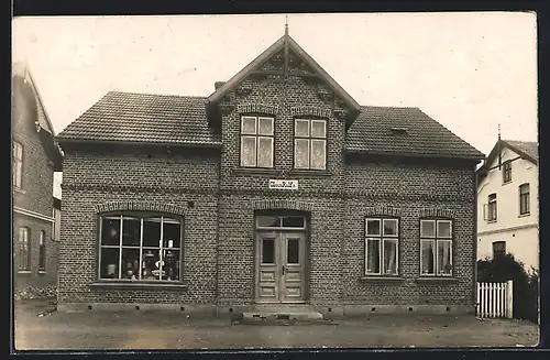 Foto-AK Neumünster, Geschäftshaus Claus Ralfs 1913