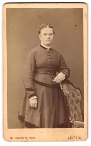 Fotografie Naumann, Leipzig, an der Promenade, Junge Dame im taillierten Kleid mit hochgesteckten Haaren