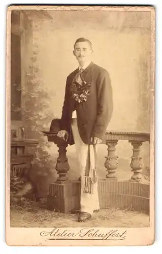 Fotografie E. Schuffert, Borna, Gutbürgerlicher Mann im schwarzen Anzug mit Schal und Blätterkranz und Brille