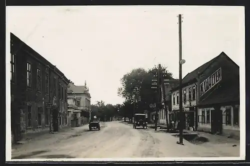 AK St. Benatky, Strassenpartie im Ortskern mit Geschäft K. Walter