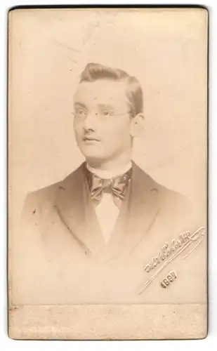 Fotografie H. Eckert, Prag, Elegant gekleideter Herr mit Brille