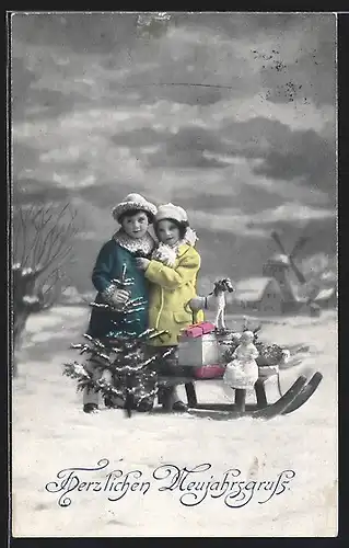 AK Kinderpaar mit Spielzeug auf einem Schlitten