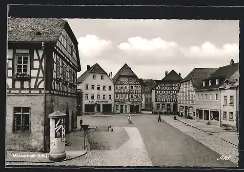 AK Münnerstadt /Ufr., Strassenpartie mit Geschäften
