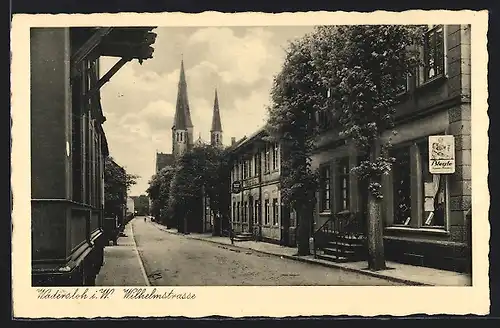 AK Wadersloh i. W., Wilhelmstrasse mit Geschäft und Kirche