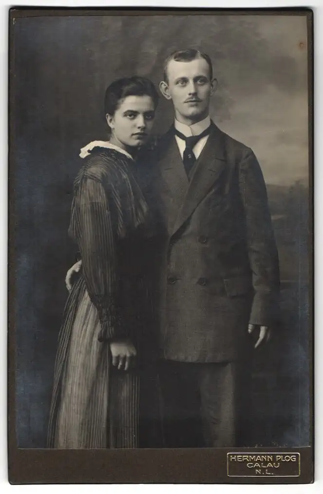 Fotografie Hermann Plog, Calau /N. L., Herr im Anzug mit Krawatte, Dame im Kleid