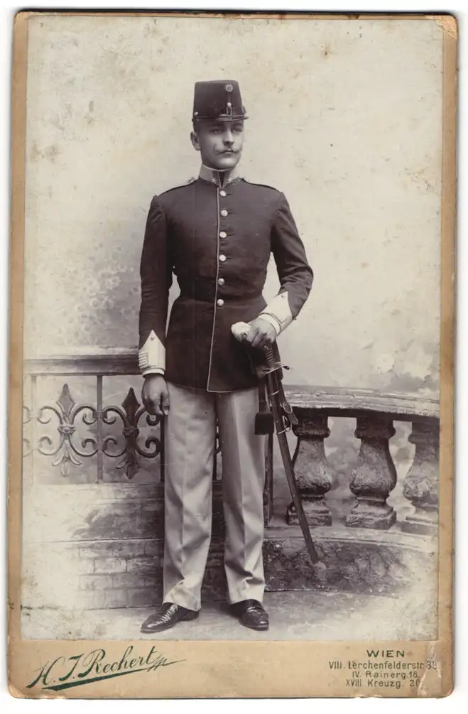 Fotografie H. J. Rechert, Wien, Lerchenfeldstr. 38, K.u.k. Soldat in Uniform m. Tschako u. Säbel