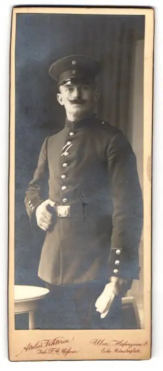 Fotografie Atelier Viktoria, Ulm, Hafengasse 2, Soldat S. Wirtz in Uniform mit Schirmmütze und Schnurrbart, 1916