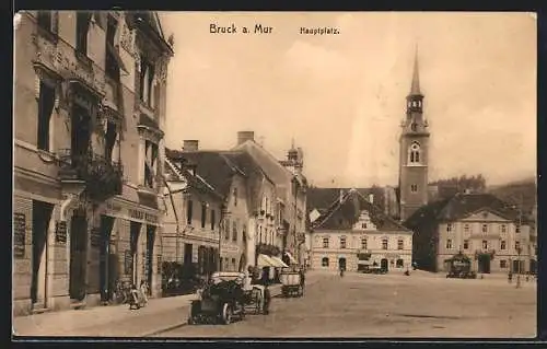 AK Bruck a. Mur, Hauptplatz mit Geschäften und Auto