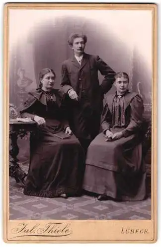 Fotografie Jul. Thiele, Lübeck, Gr. Burgstr. 33, Junger Herr und zwei Damen in modischer Kleidung