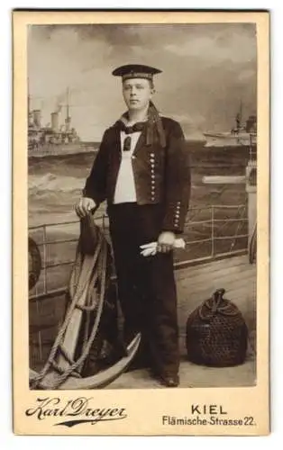 Fotografie Karl Dreyer, Kiel, Flämische Str. 22, Matrose in Uniform, Mützenband Matrosen Division I. vor Studiokulisse