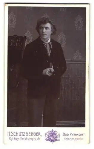 Fotografie H. Schlitzberger, Bad Pyrmont, Helenenquelle, Junger Mann im Smoking mit welligem Haar, mit einer Pfeife