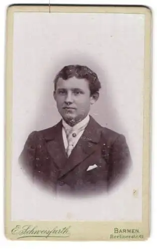 Fotografie E. Schweisfurth, Barmen, Berlinerstr. 61, Jugendlicher Knabe mit lockigem Haar im Anzug mit Krawatte