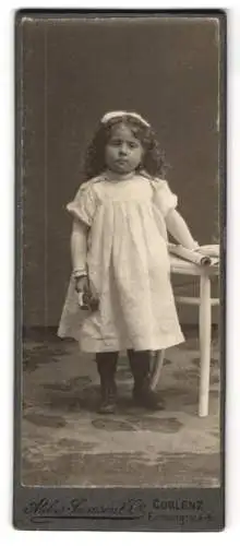 Fotografie Atelier Samson & Co., Coblenz, Firmungstr. 4-6, Kleines Mädchen mit lockigem Haar im weissen Kleid