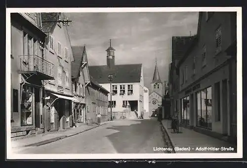 AK Lichtenau /Baden, Strasse mit Geschäften, Turmgebäude und Kirche