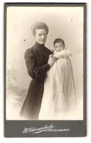 Fotografie R. Schwarzbach, Bitterfeld, junge blonde Mutter hält ihre Kind im Arm, Mutterglück