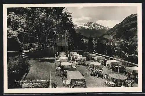 AK Badgastein, Gasthaus zur schwarzen Liesl mit Blick auf die Berge