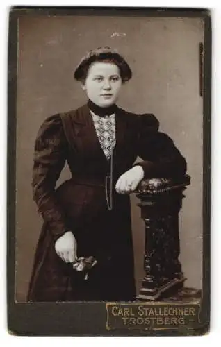 Fotografie Carl Stallechner, Trostberg, Junge Dame im schwarzen taillierten Kleid mit einem Blumenstrauss in der Hand