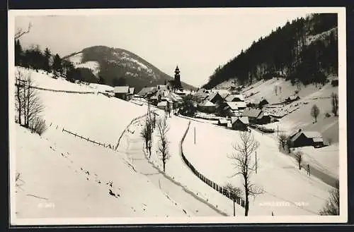 AK Annaberg, Ortsansicht mit Landstrasse im Schnee