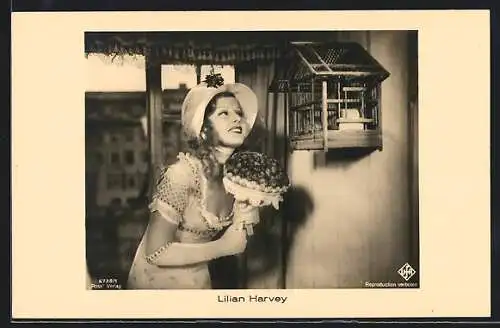 AK Schauspielerin Lilian Harvey mit einem Blumenstrauss