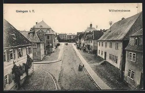 AK Usingen i. T., Wilhelmstrasse mit Schreibwarengeschäft