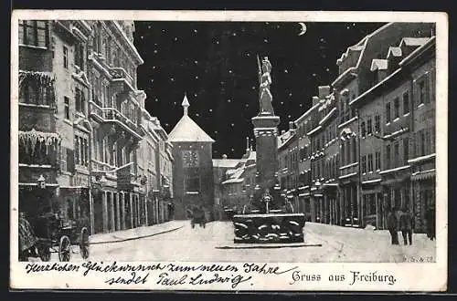 AK Freiburg / Breisgau, Strassenpartie mit Brunnen im Winter