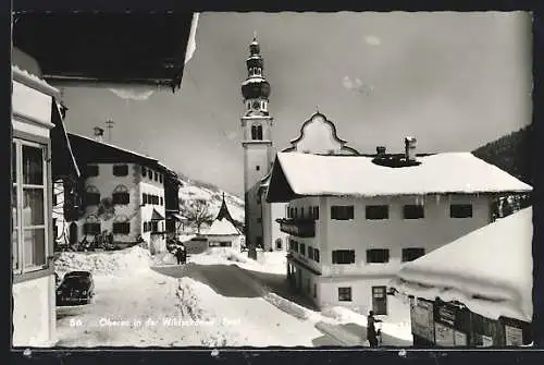 AK Oberau, Strassenpartie mit Kirche im Schnee