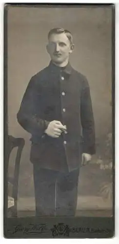 Fotografie Georg Wilke, Berlin, Badstr. 36, Soldat in Uniform raucht Zigarre