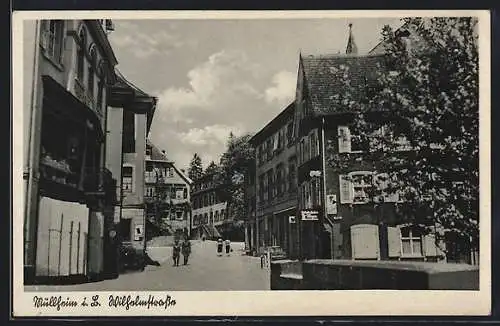 AK Müllheim i. B., Wilhelmstrasse mit Geschäft