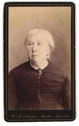 Fotografie W. M. Ostroga, Menton, Ältere Dame im Kleid mit Kragenbrosche