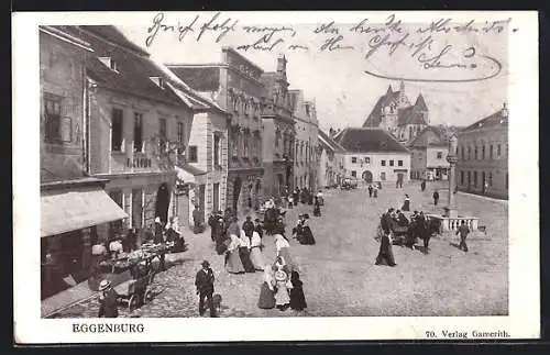 AK Eggenburg, Strassenpartie mit Geschäft und Kirche