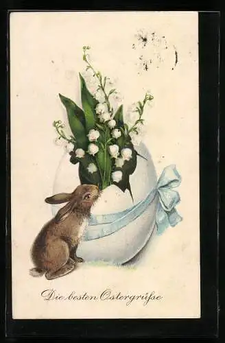 Künstler-AK Osterhase beschnuppert die Osterglocken in einem zerbrochenem Ei