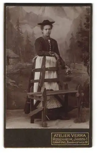 Fotografie Atelier Verra, Rosenheim, junge Frau in Tracht mit heller Schürze vor einer Studiokulisse