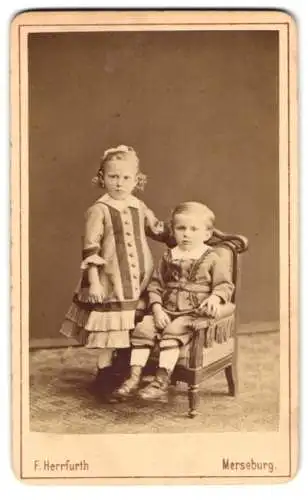 Fotografie F. Herrfurth, Merseburg, Brühl 4, Mädchen Mariechen nebst Knabe auf Sessel sitzend