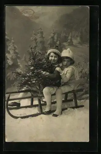 AK Zwei kleine Kinder mit Tannenbäumchen auf einem Schlitten