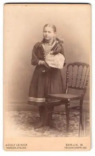 Fotografie Adolf Leiner, Berlin, Friedrichstr. 190, junges Mädchen mit Puppe im Arm und geflochtenem Zopf