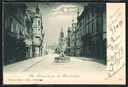 AK Freiburg i. B., Kaiserstrasse mit Brunnen im Mondschein
