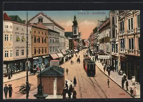 AK Linz a. D., Landstrasse mit Geschäften und Strassenbahn